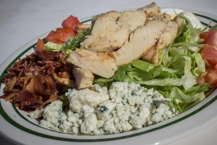 The Cobb Salad, featuring iceberg lettuce, chopped chicken, diced tomatoes, hard-boiled egg, Gorgonzola cheese and bacon, at Marina 84 Sports Bar & Grill.