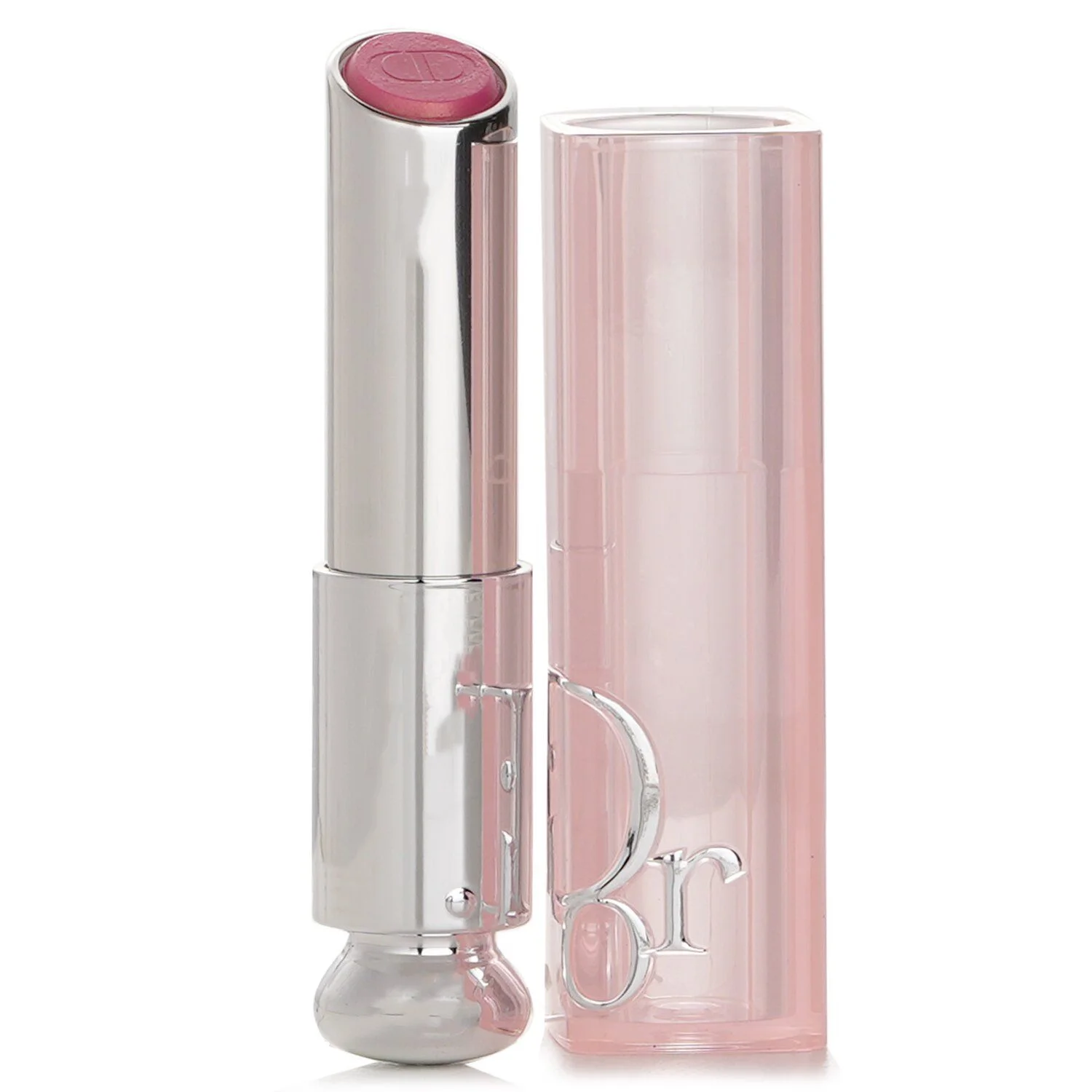A close-up studio shot of a Dior lipstick with a pink shade and silver packaging, standing next to its transparent pink cap, isolated on a white background. The lipstick bullet features a subtle embossed 'CD' logo. The cap has the 'Dior' logo embossed in silver lettering.