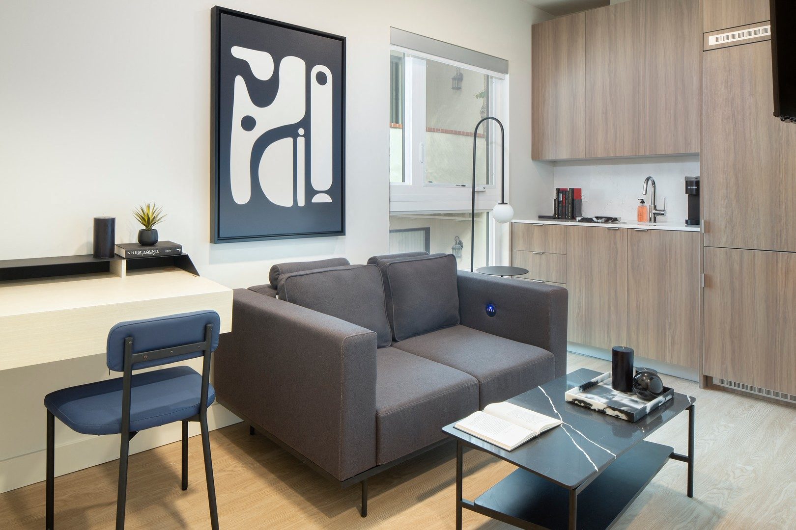 a living room with a gray couch and a coffee table