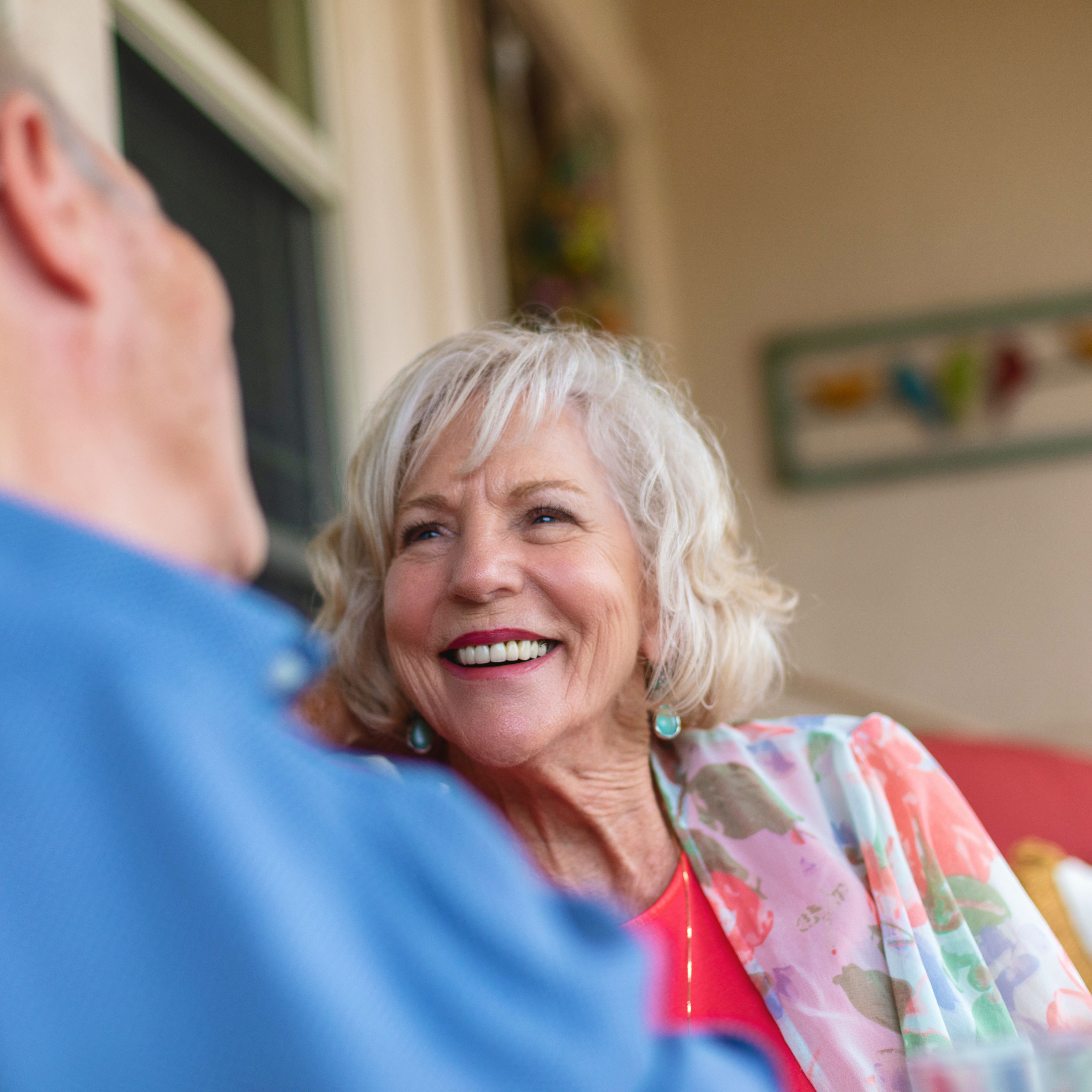 A woman smiling at her husband discussing PD catheter placement