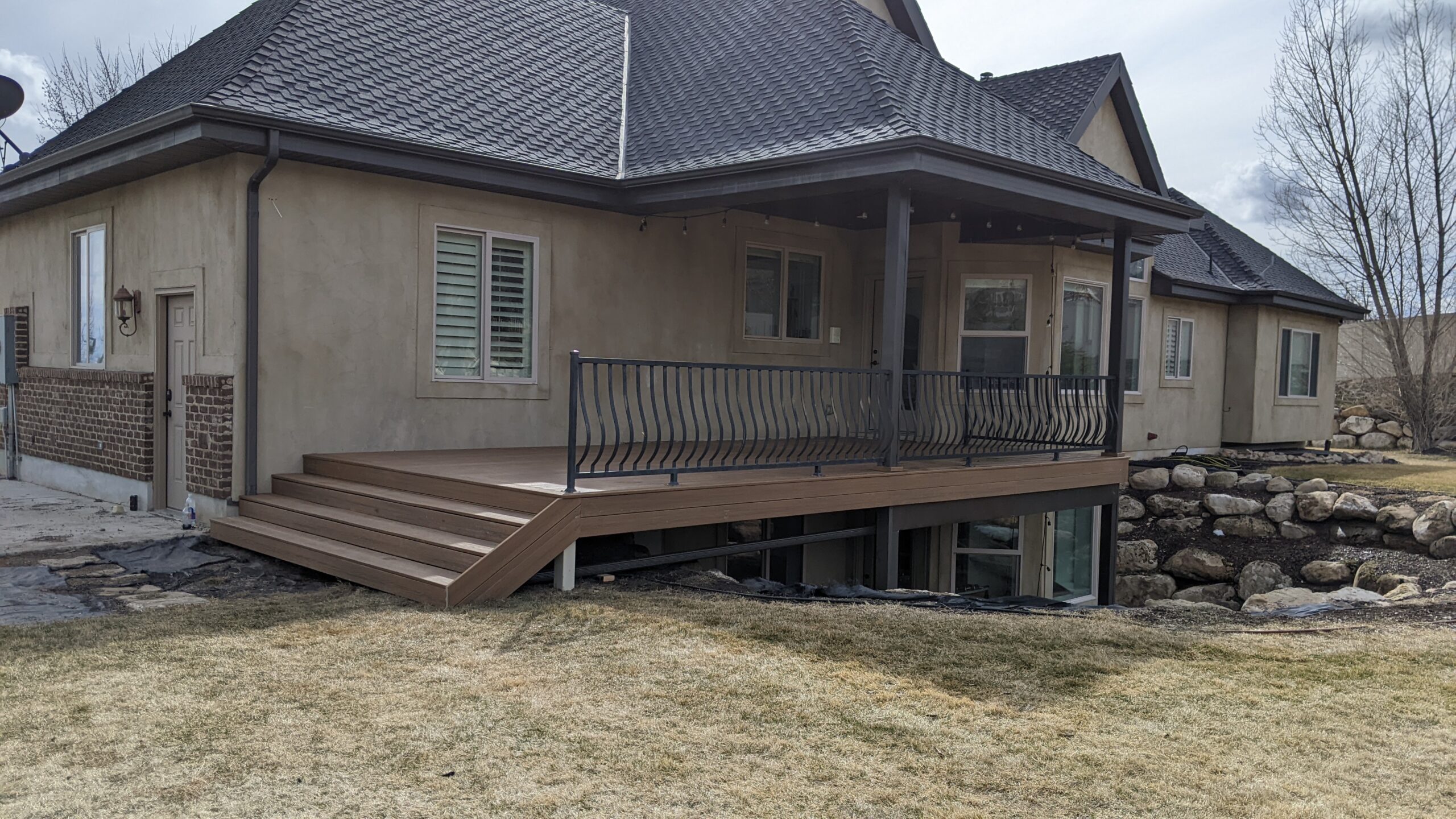 Expand your outdoor living space with this custom deck project by DeckPro LLC, designed to blend rustic charm with modern durability. This build features low-maintenance composite decking and a unique perimeter railing that combines natural wood posts with wire mesh infill panels. The functional design includes extensive built-in bench seating, making it an inviting retreat perfect for relaxing and taking in scenic, natural views.