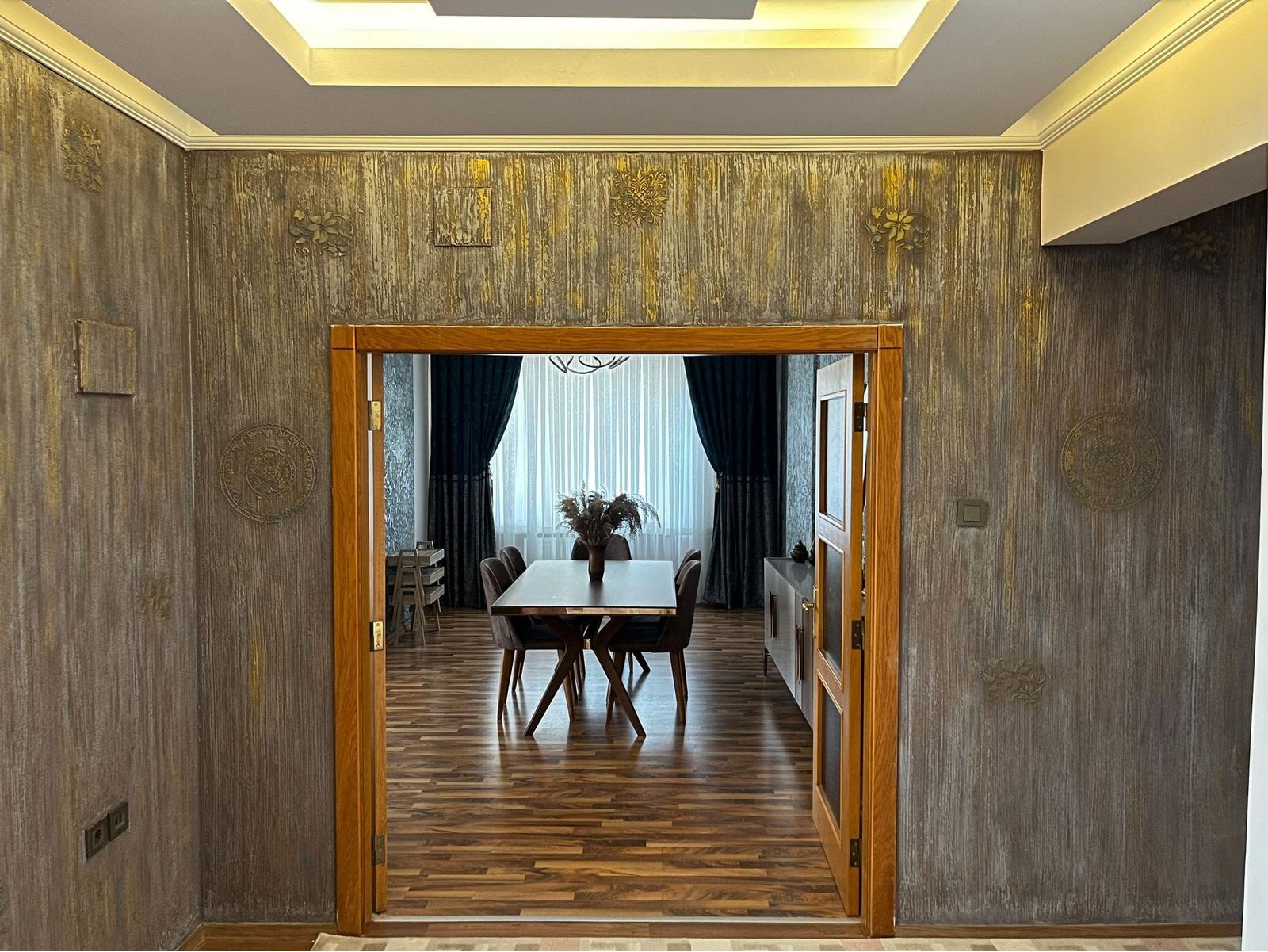 Step into a space that speaks of class — featuring high-end decorative wall textures, warm-toned wooden frames, and elegant ceiling layering. Perfect for clients seeking premium finishes with a rustic-modern blend.