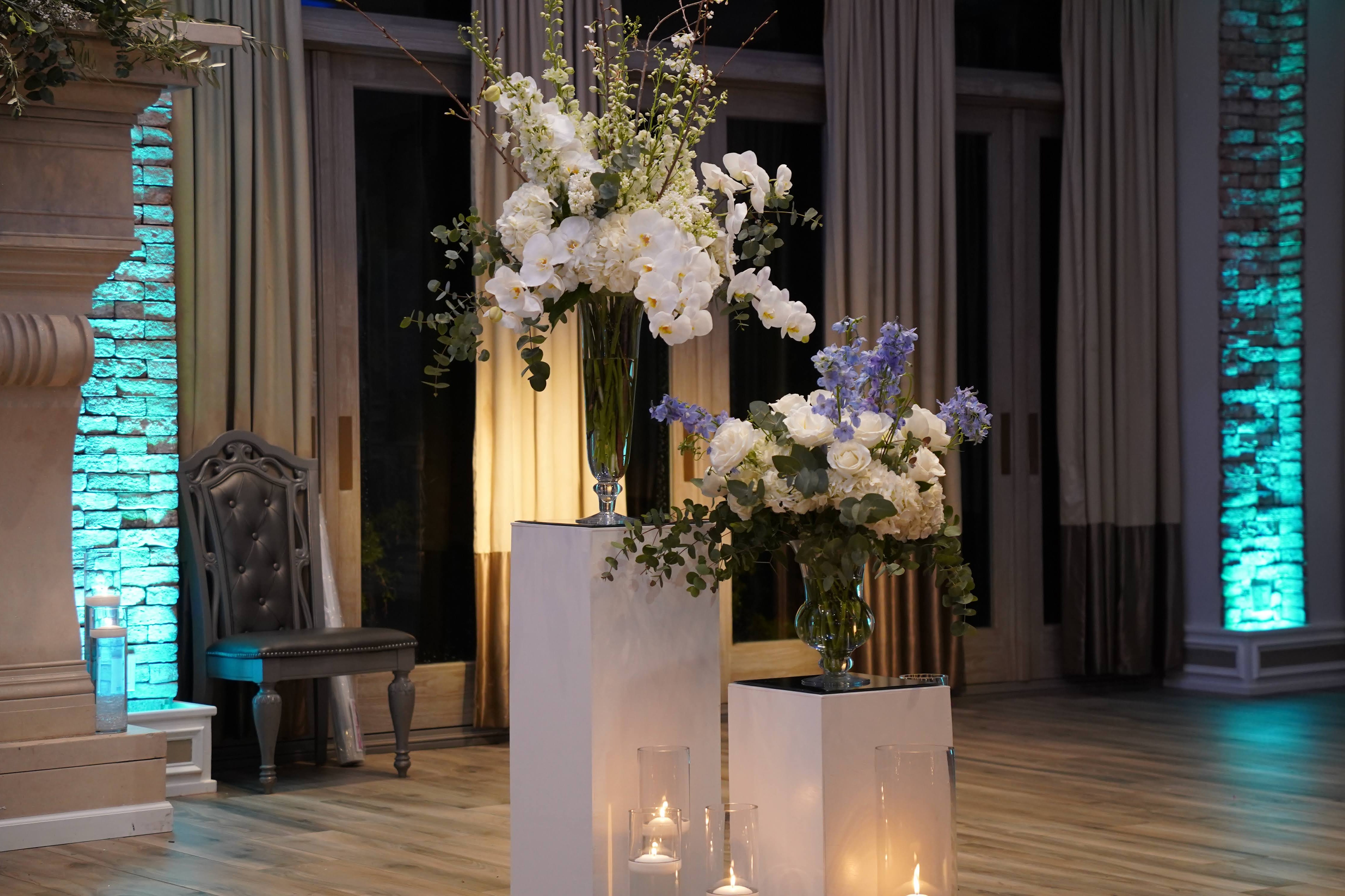 March wedding, The Somerley at The Fox Hollow, Woodbury, NY. Pedestal arrangements with white and blue color palette for ceremony flowers