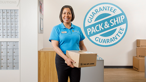store associate next to mailboxes inside a ups store