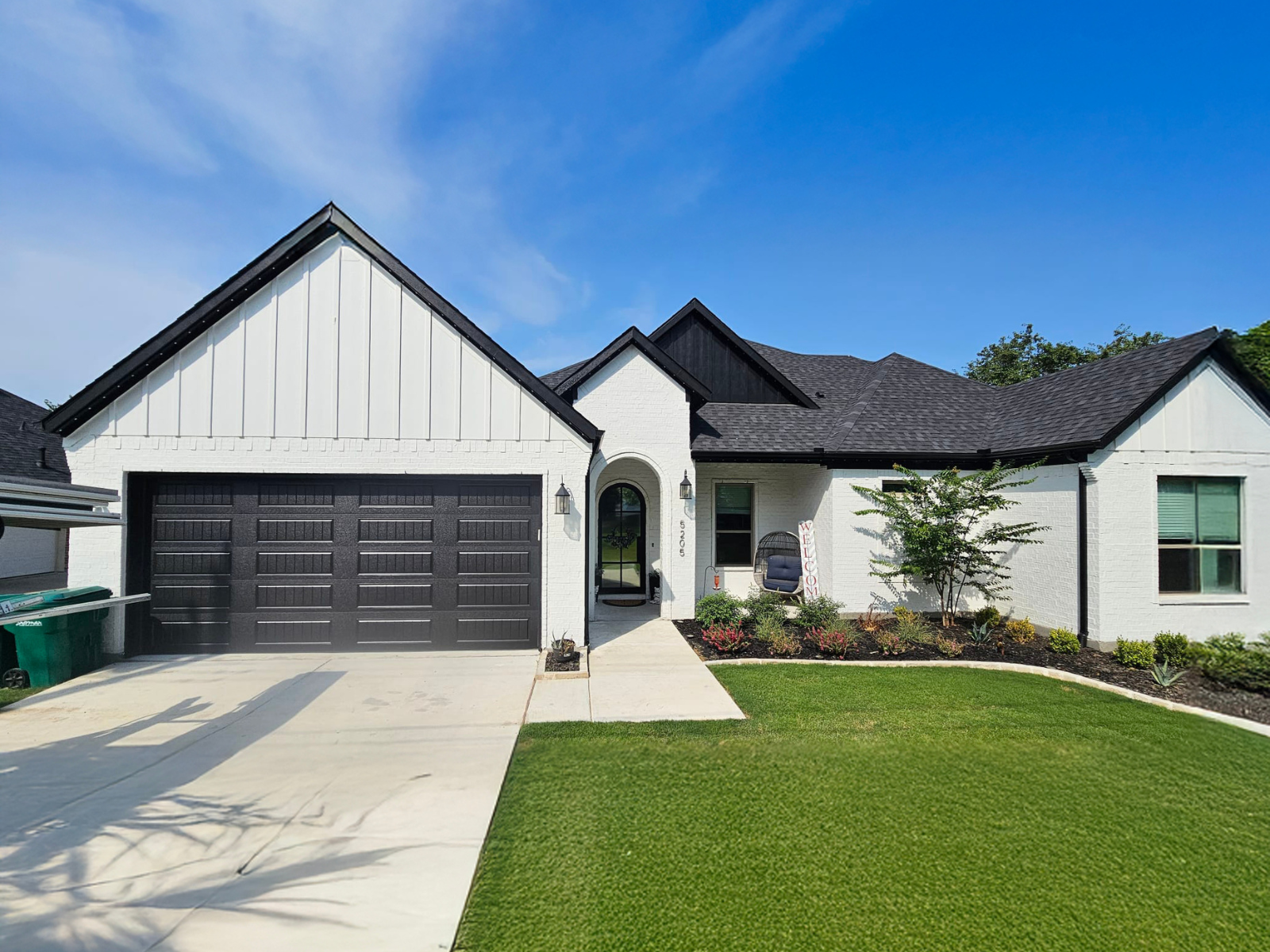 A completed garage door installation on a modern farmhouse-style home.