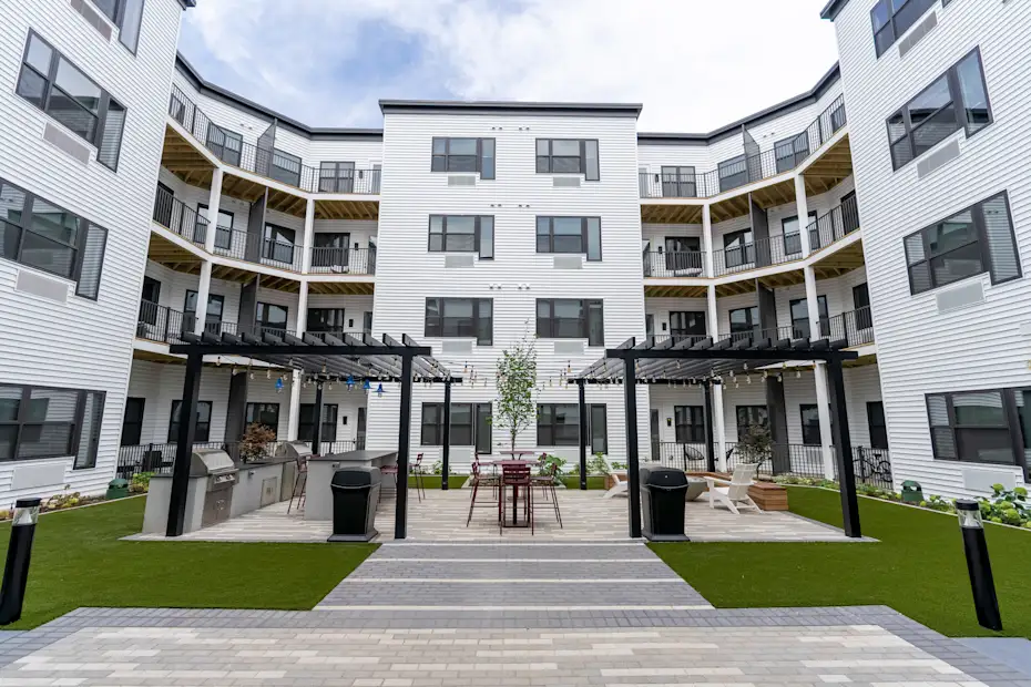 A modern apartment complex with a central courtyard and balconies 