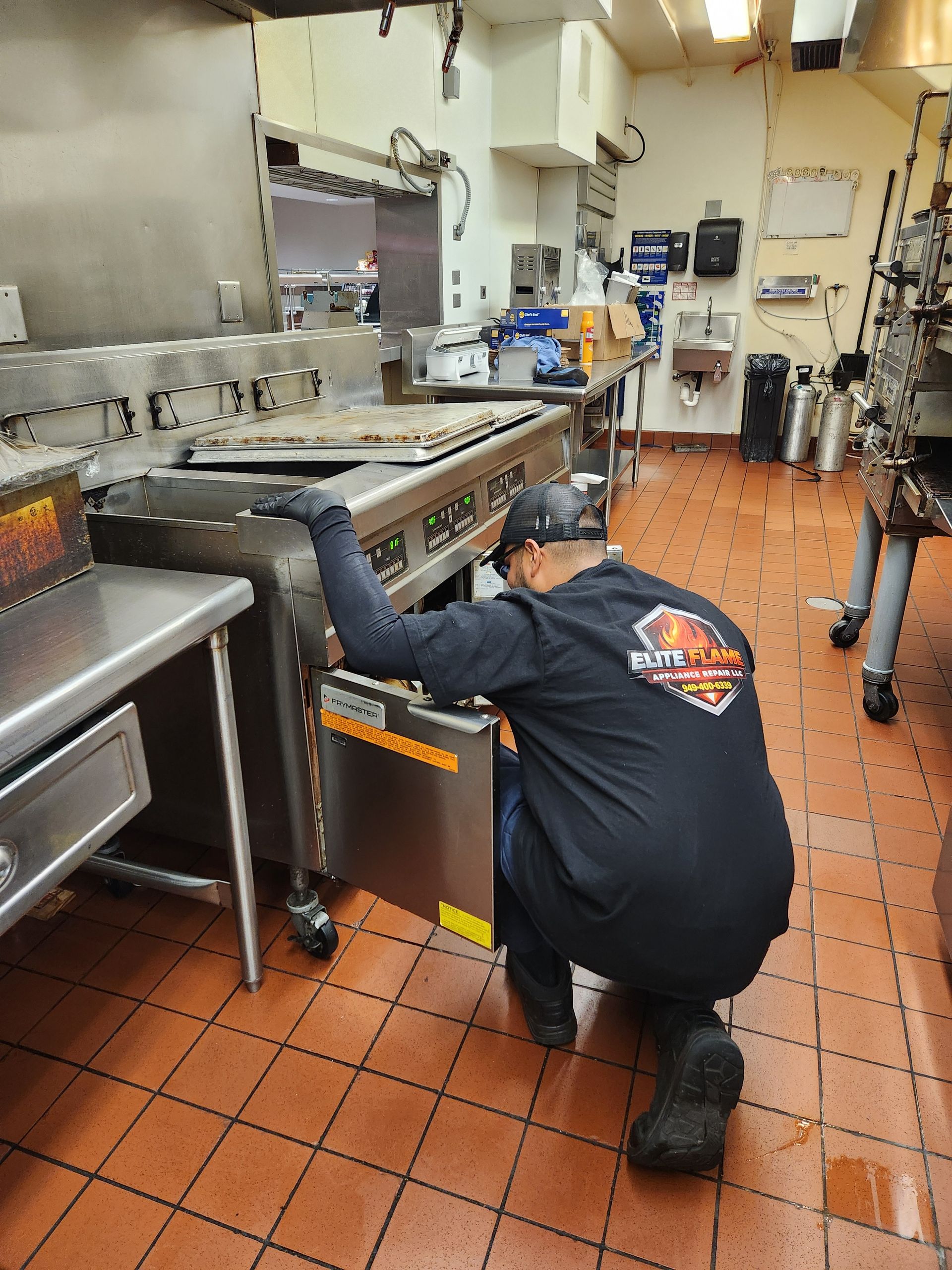 Commercial rooftop HVAC unit opened for service, exposing electrical wiring and internal components, 