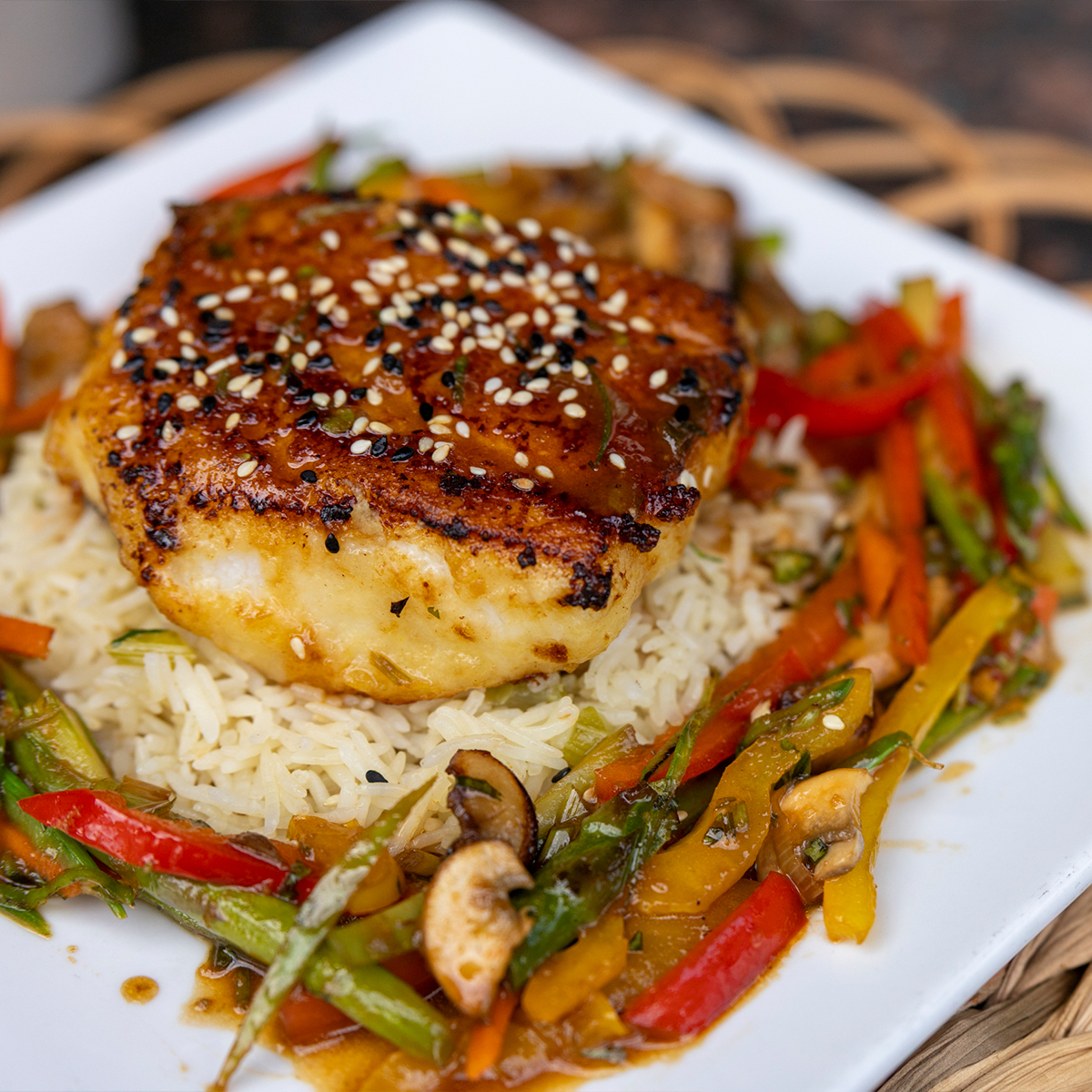 Pan Seared Sea Bass | brandy-garlic crust, stir fried vegetables, basmati rice & asian sesame vinaigrette