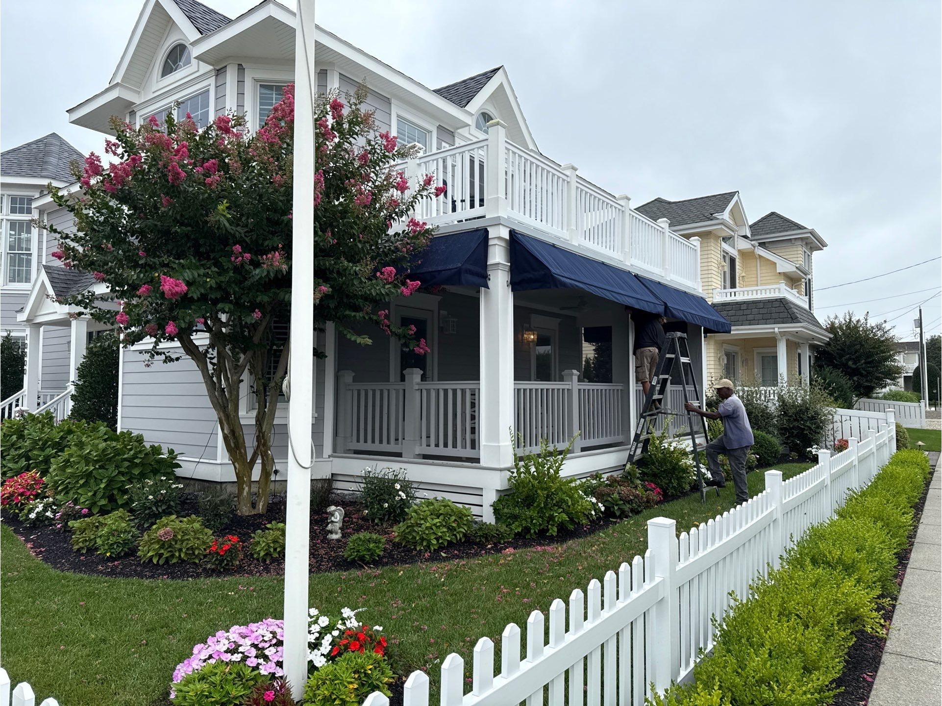 Covered front porch with railings and exterior trim details