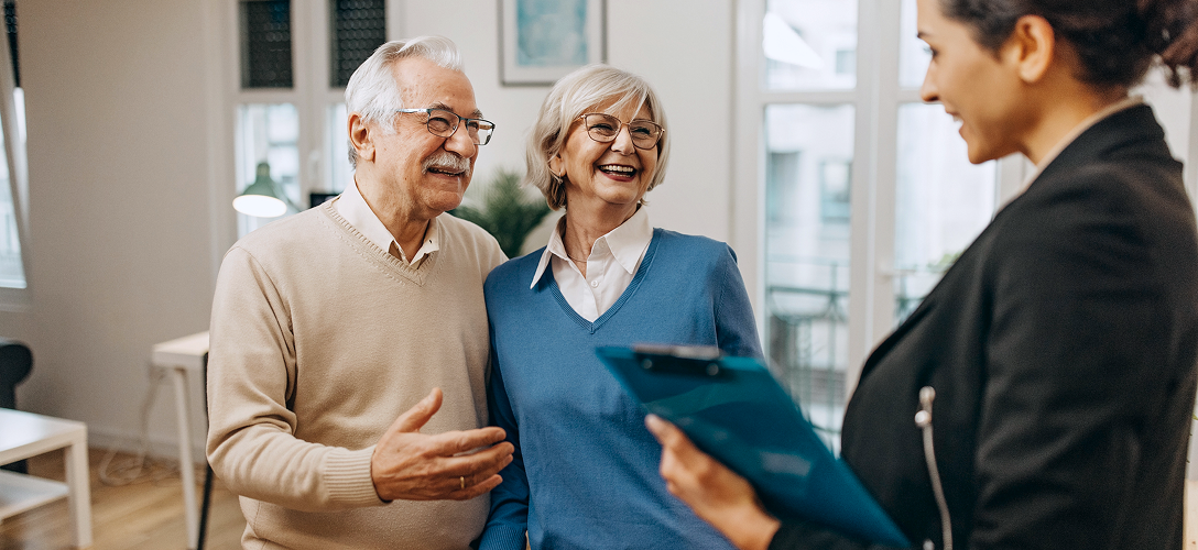 An advisor speaking with clients in an office setting.