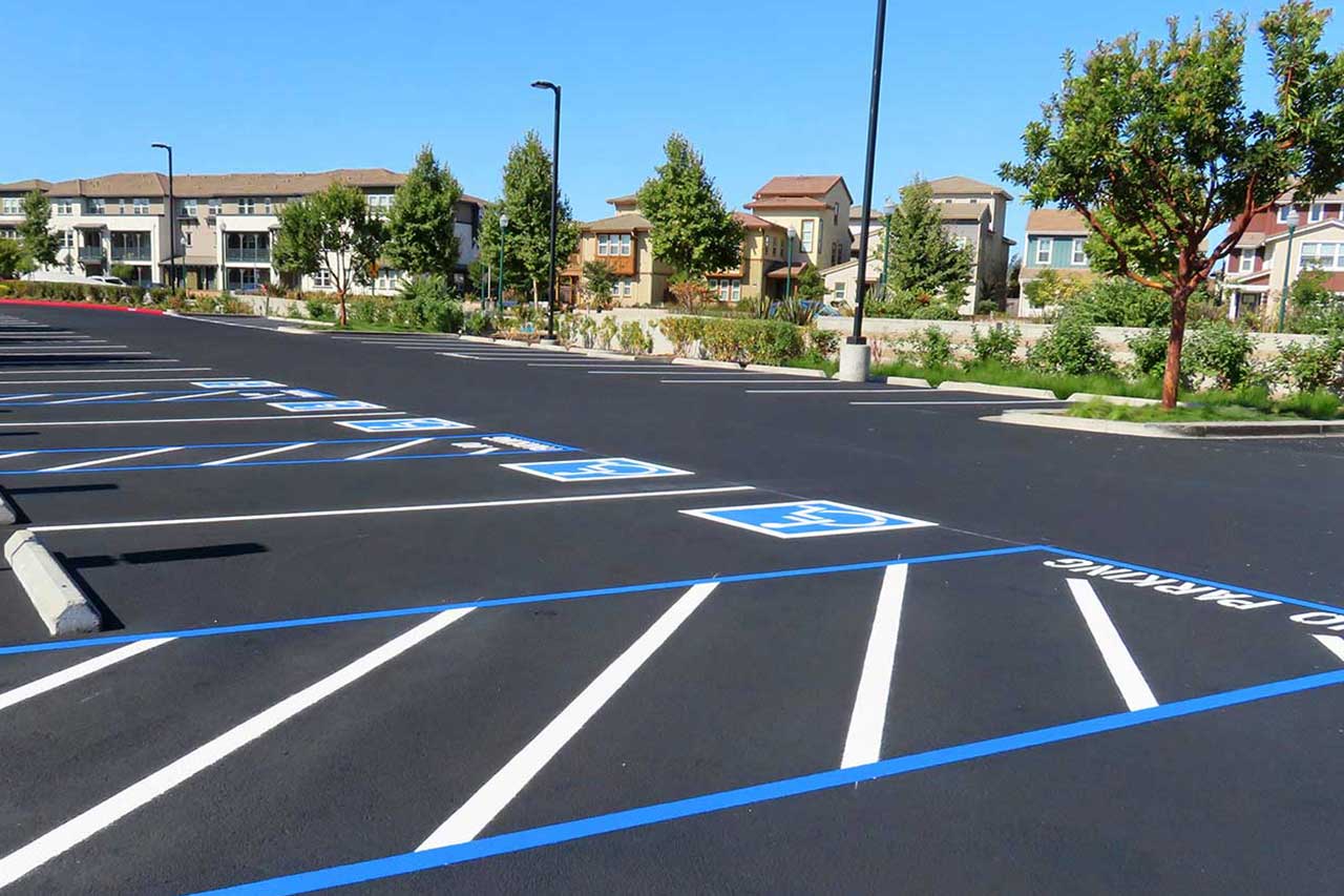 Professional ADA handicap symbol striping, providing clear, compliant parking lot accessibility markings.
