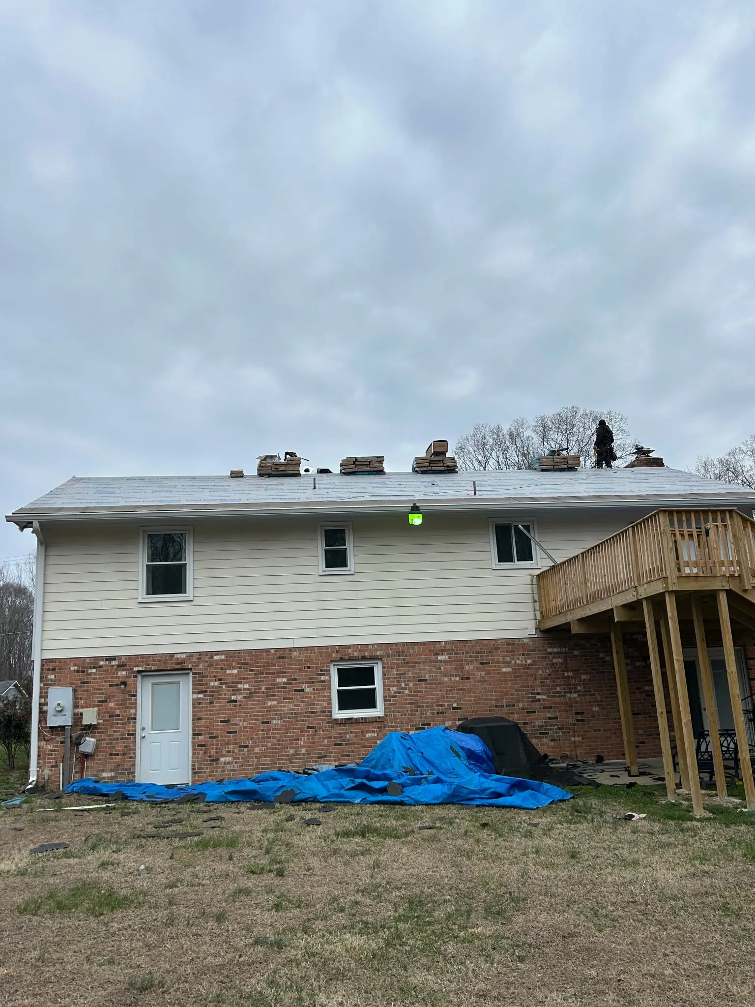 Residential roof prepared with underlayment before new shingles are installed. 