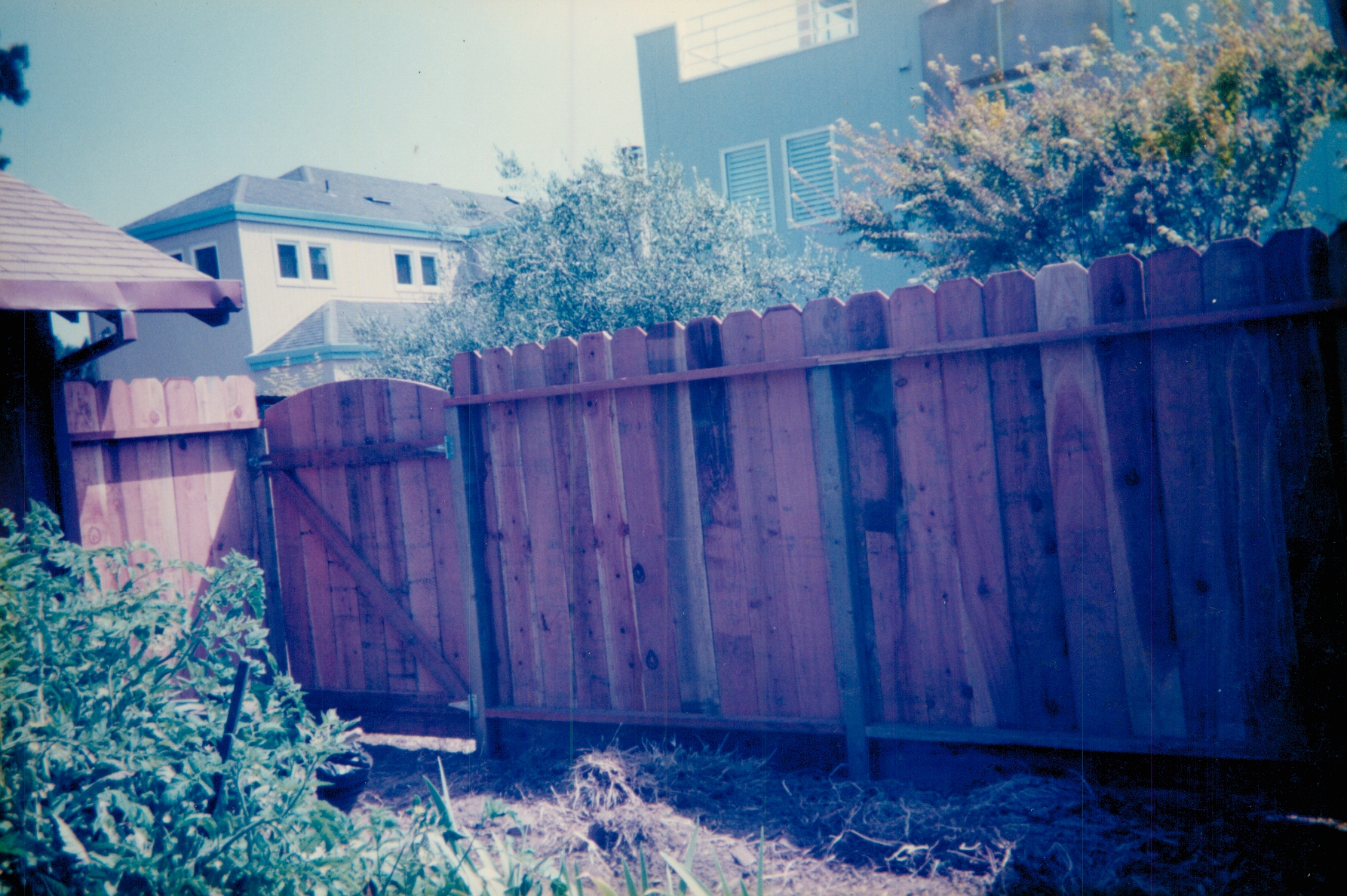 Custom wood privacy fence installed on a sloped property to create a secure and enclosed outdoor space.