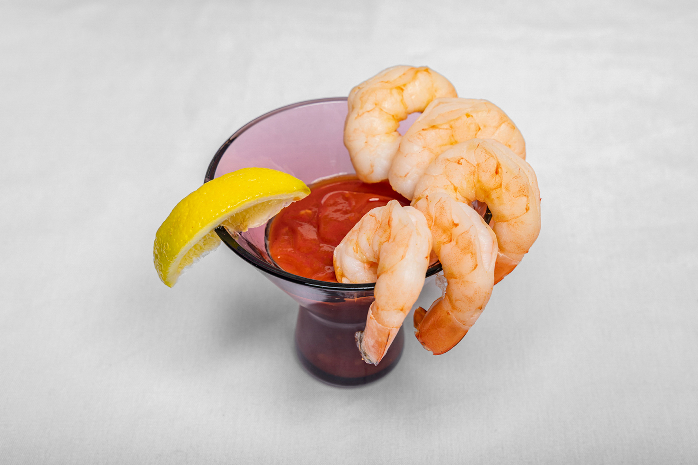 Chilled, perfectly cooked shrimp served with a zesty cocktail sauce for a refreshing bite.