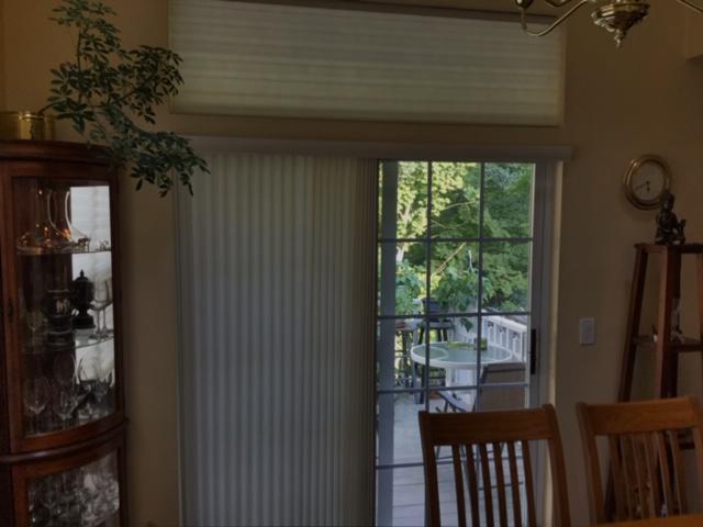 This homeowner was looking for something to upgrade her home and she found the perfect solution. She treated her windows to 2" Honeycomb Shades by Budget Blinds of Ossining and decided to install them on both the windows and the glass door and was more than satisfied with the end result. They provid