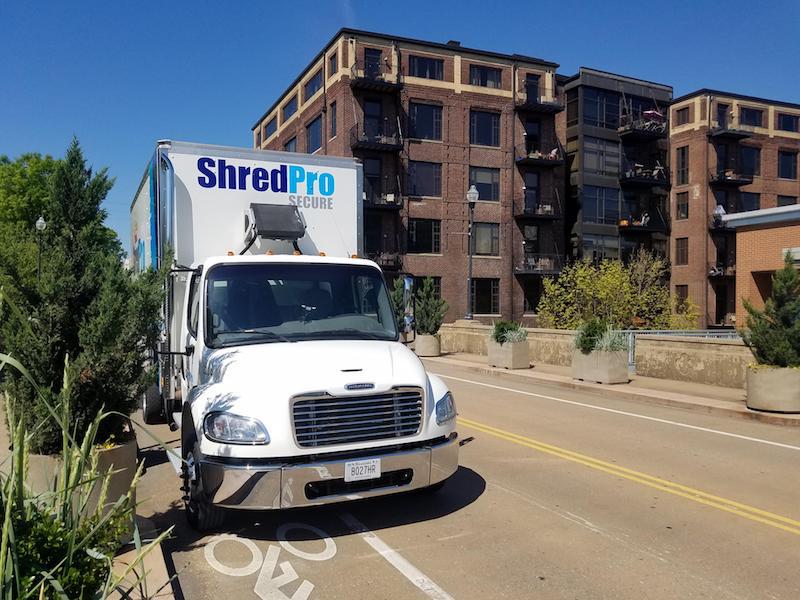 ShredPro Secure mobile shredding truck in front of a Knoxville apartment building