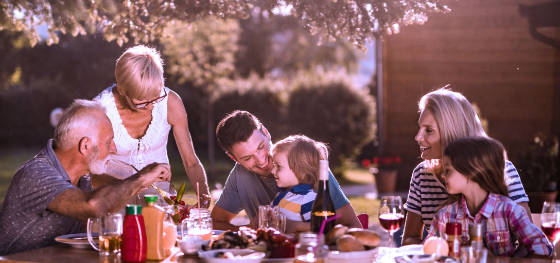 A multigenerational family eating a meal.
