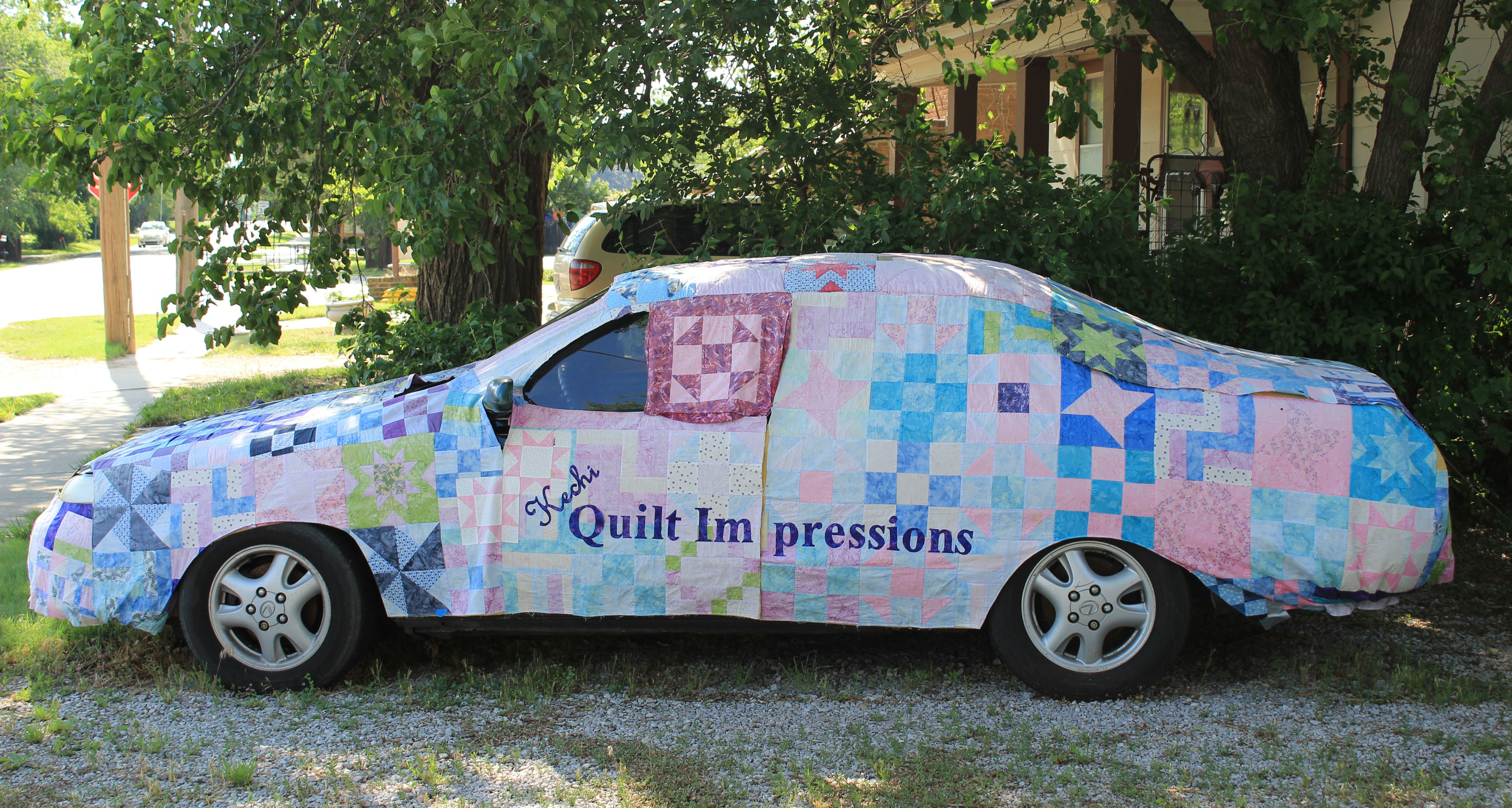 Quilted car cover made for the Miracle Block Project. Quilt blocks are make by quilters from all around Kansas. This project was a Girl Scout Award project coordinated by Girl Scout Rachel Evans. The purpose was to support fundraisers for Kyle Hicks and the Children's Organ Transplant Assoc. This car cover used to be at the entrance to the shop but now can be seen on our facebook page www.facebook.com/KechiQuilt.