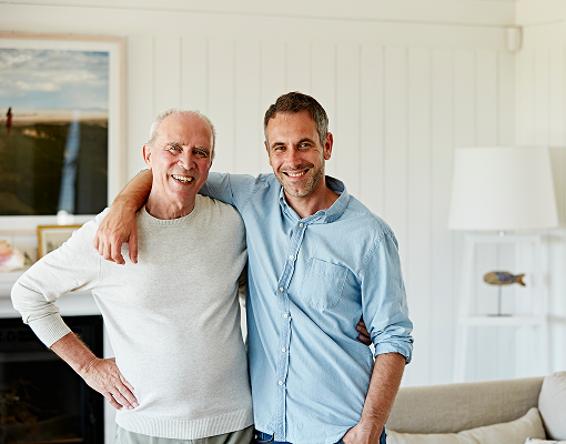 A father and son smiling at the camera.