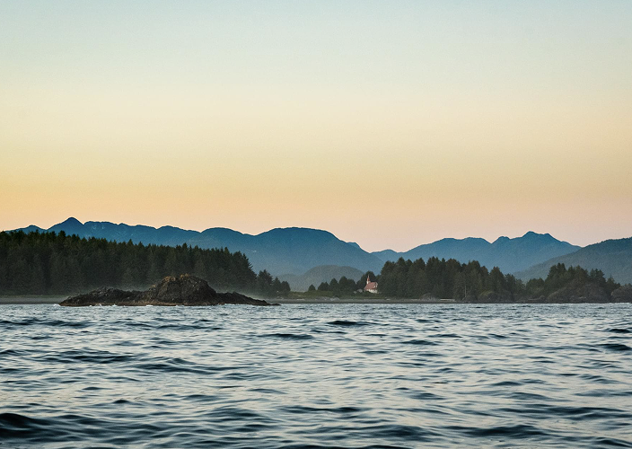 Choppy water with mountains in the background.