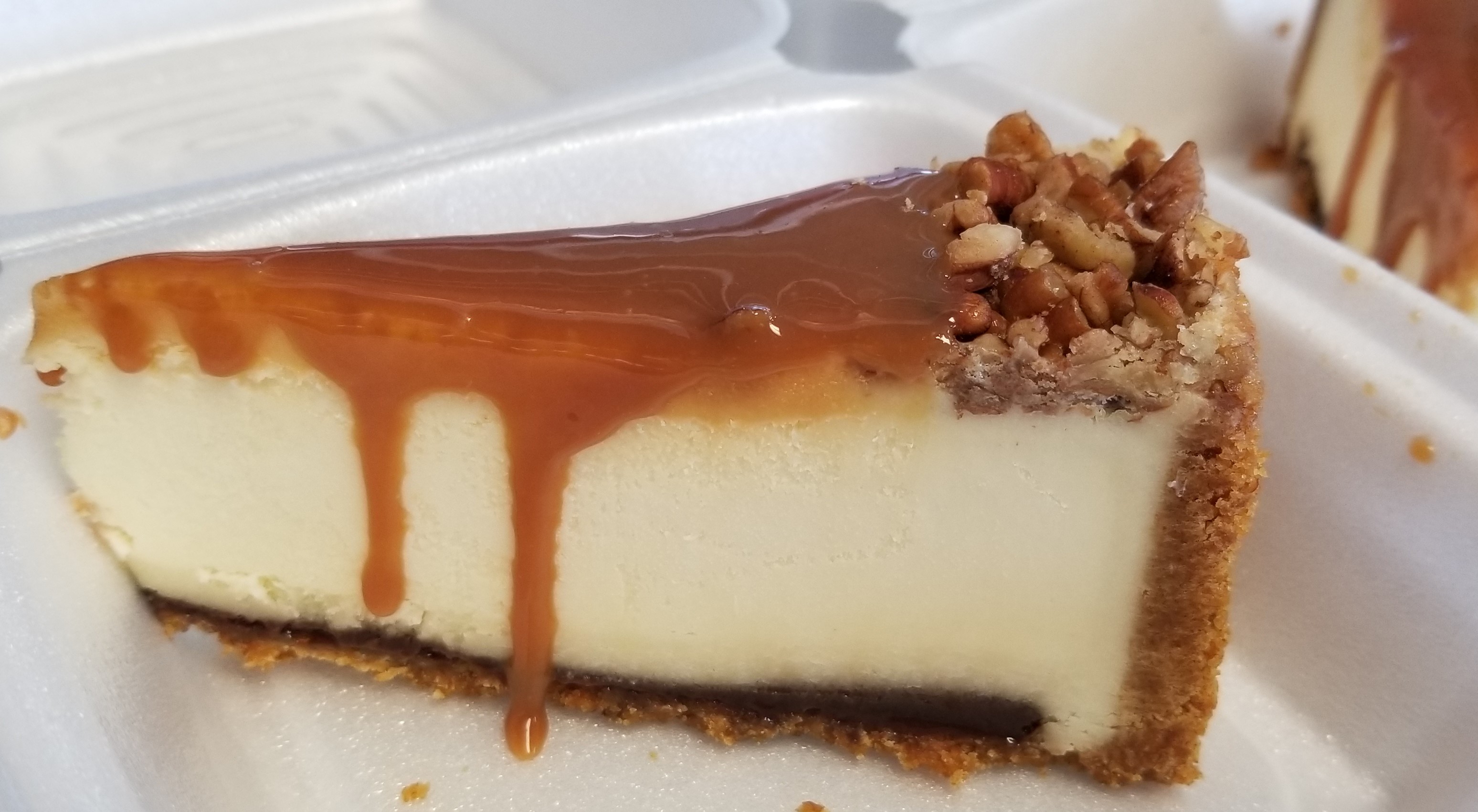 Caramel Fudge Cheesecake! A classic New York Cheesecake with a layer of caramel on top with candied roasted pecans and a thin layer of fudge on the bottom above the graham cracker crust!