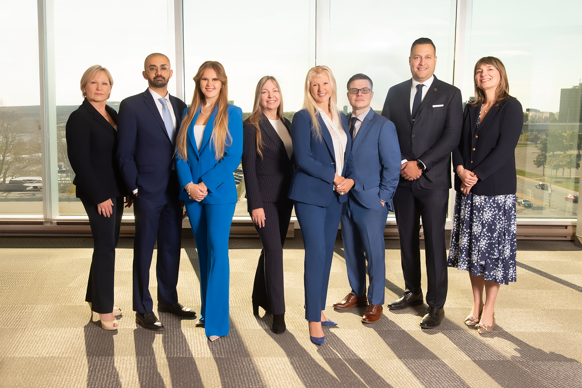 The Racine-Marcotte Advisory Group team photo in a modern office setting
