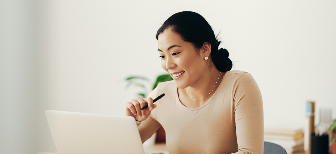 Woman working on a laptop.