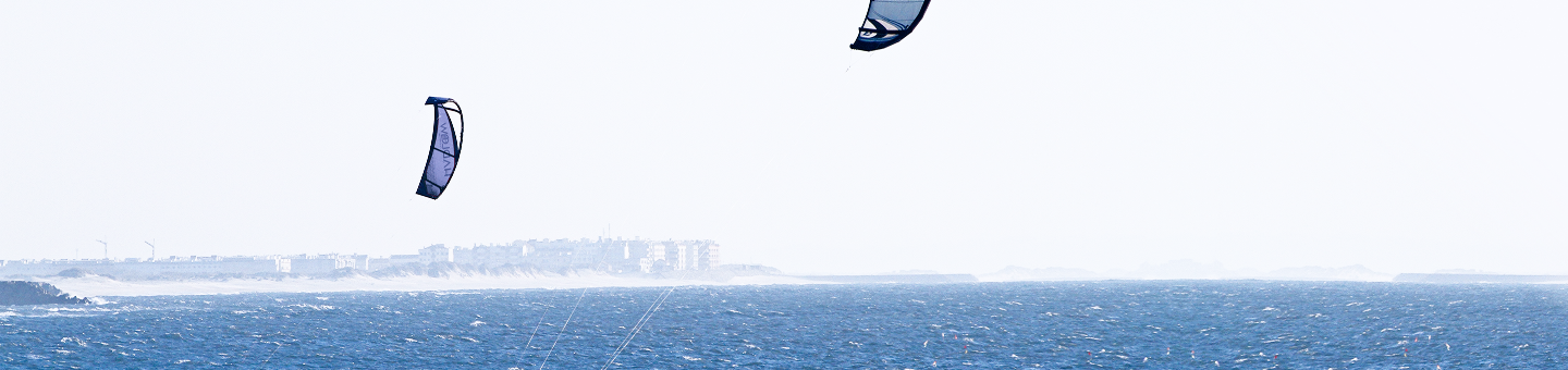 Kites flying over a lake.