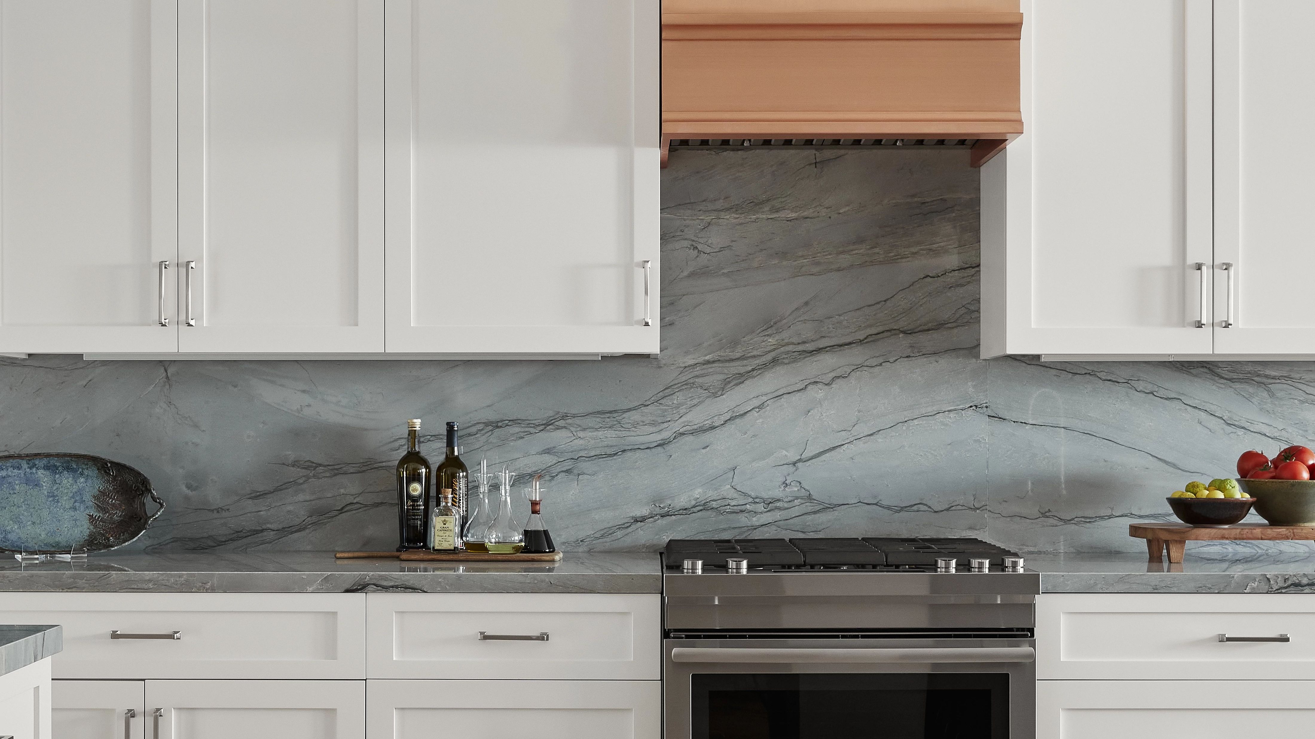 Blue Tahoe quartzite has a blue-toned, silver background with grey veining and various areas of white throughout.