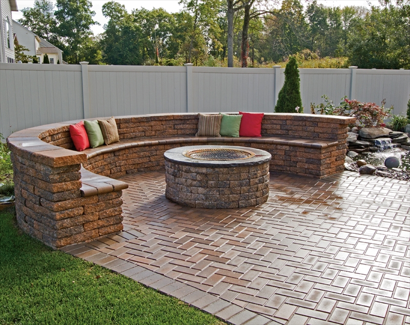 Circular fire pit with round stone bench seating