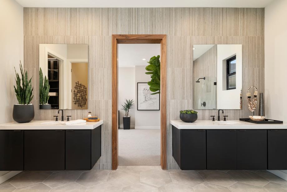 Spa-like primary bathrooms with dual-sink vanities, freestanding soaking tubs, and large walk-in showers