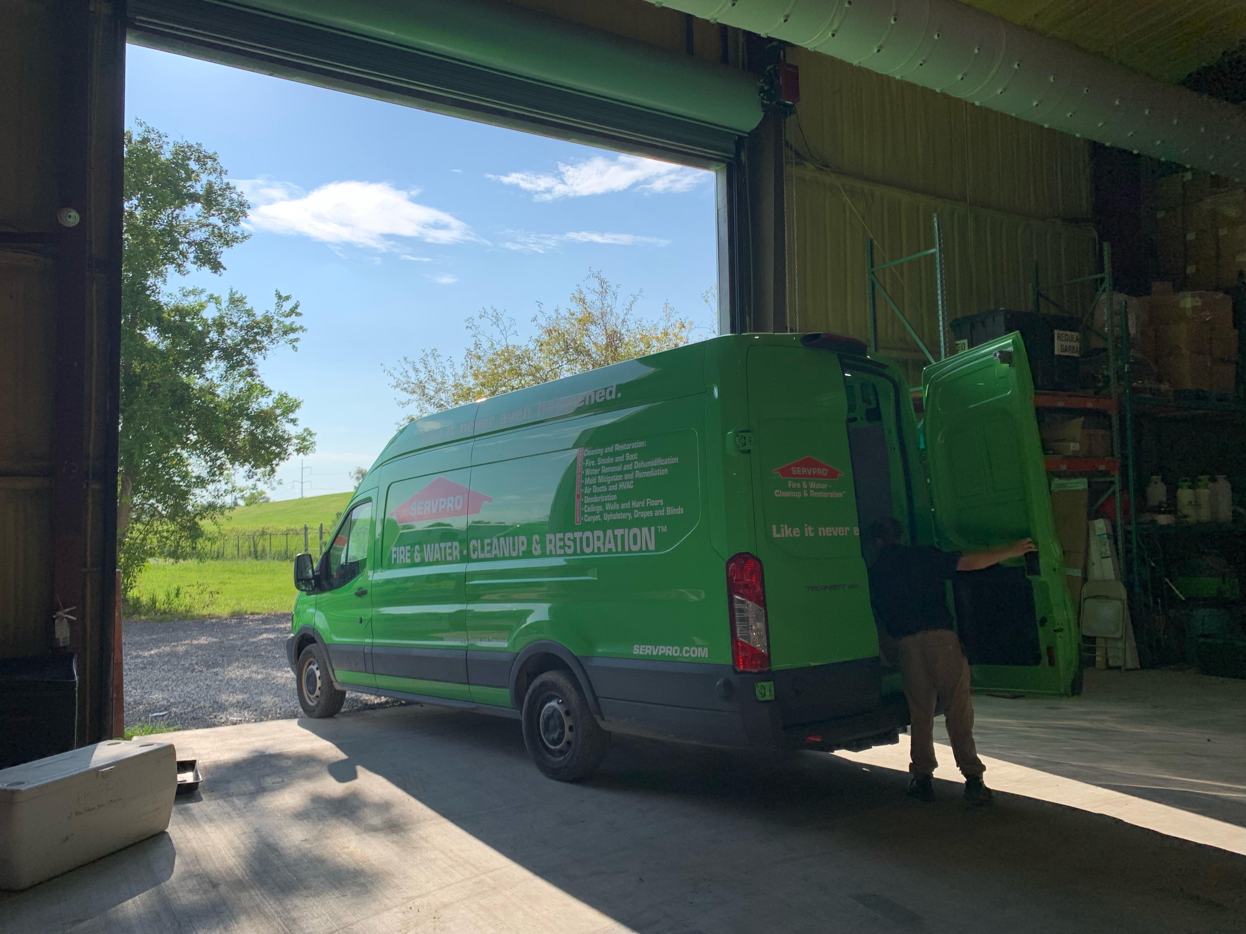 A SERVPRO crew member loading up a work van and preparing to start the day.
