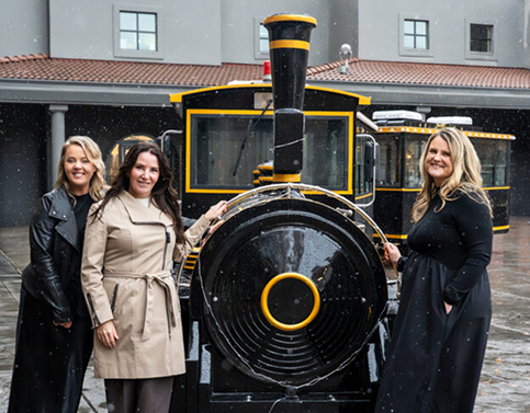 The Hymers Private Wealth team posing with The Dreamer Express.