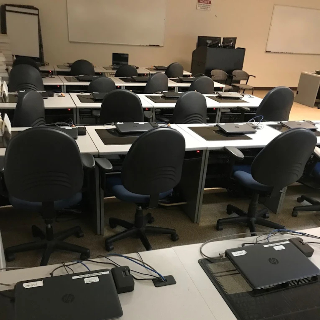 Computer lab desks, chairs, and equipment staged for relocation by Econo Move & Storage’s commercial 