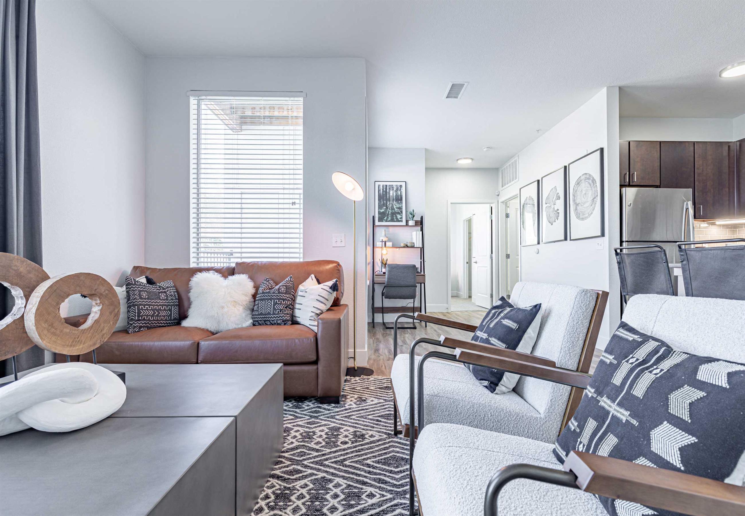 a living room with a couch and two chairs