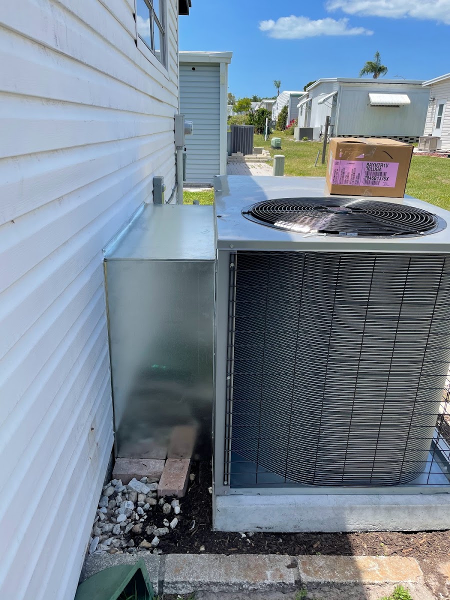 Outdoor air conditioning condenser installed beside a residential property to provide dependable cooling and energy-efficient comfort.