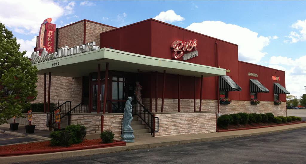 Red and brick Buca di Beppo Castleton Square exterior with a statue at the front.