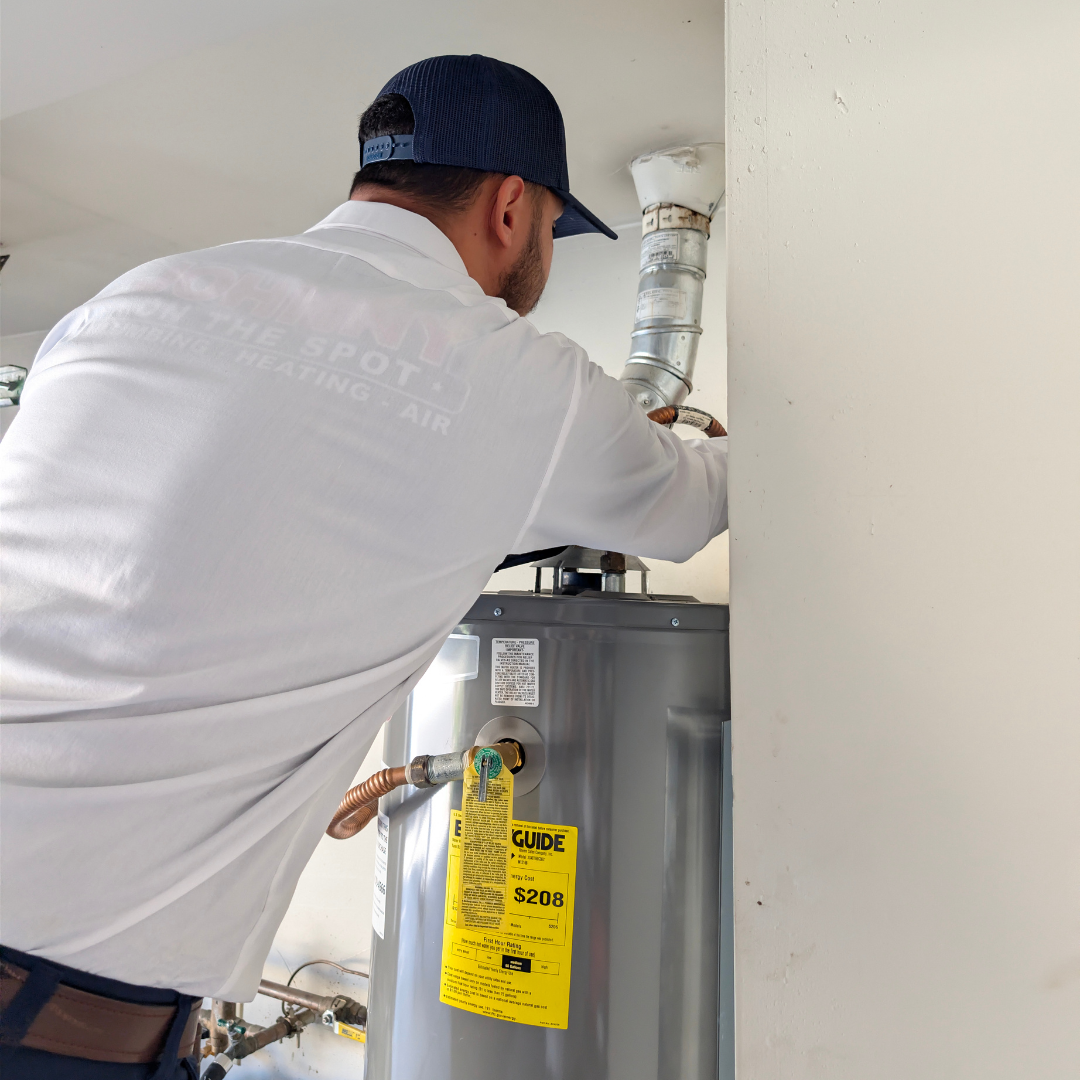Technician inspecting a home water heater. 