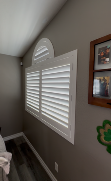 These custom white shutters showcase a perfect fit for specialty-shaped windows, featuring a beautiful arched sunburst top. The clean lines and classic louvers provide a sophisticated look for any room.