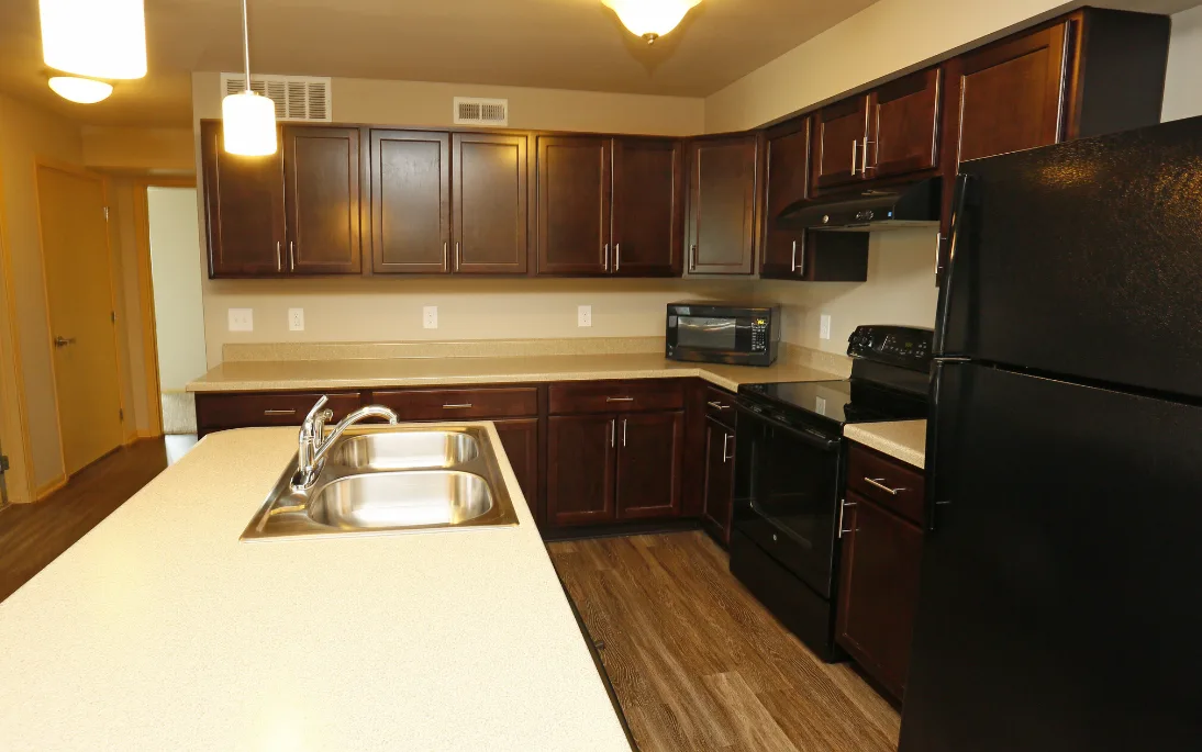 Kitchen with hardwood floors and appliances