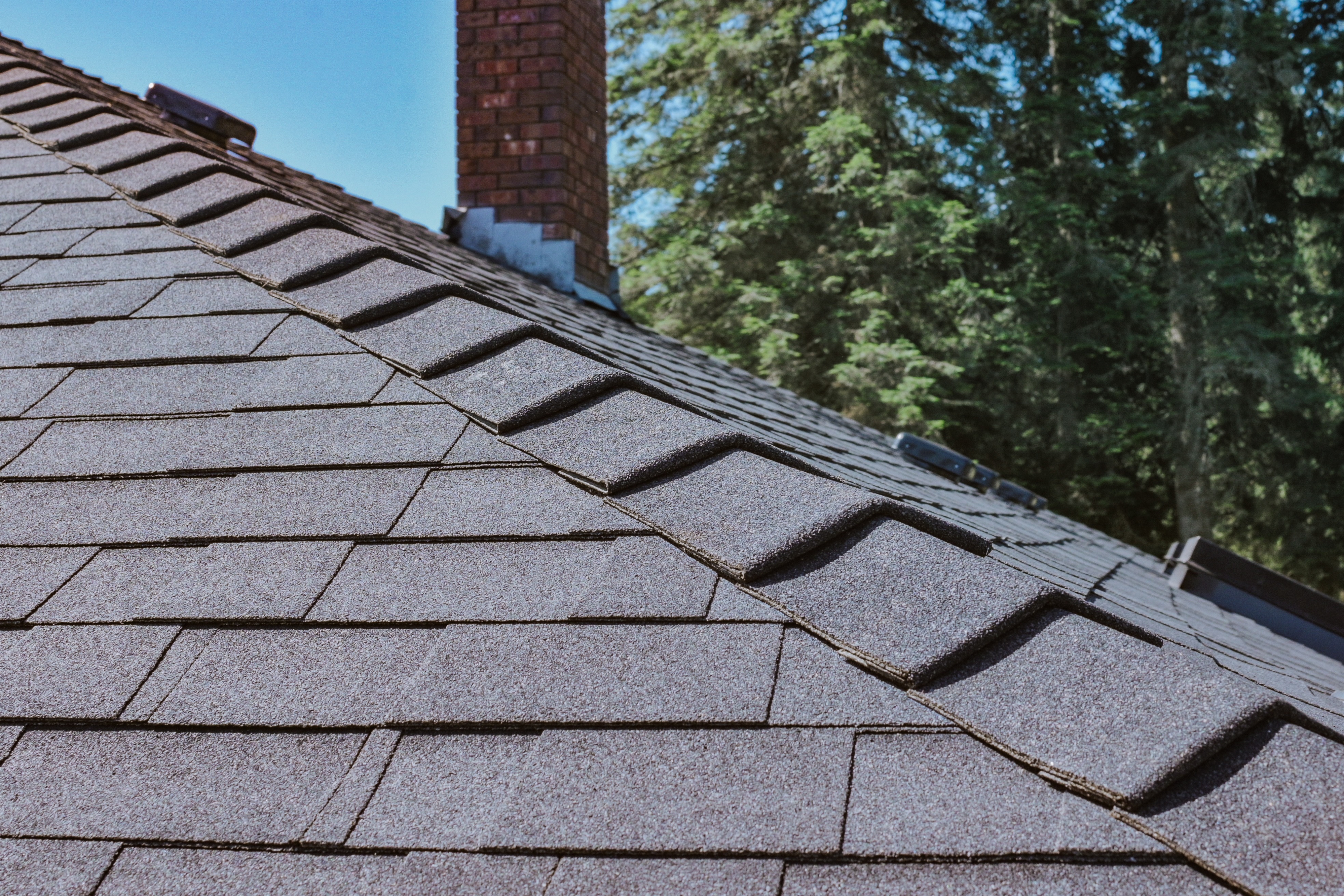 Finished residential asphalt shingle roof showing clean installation along the roof edge. 