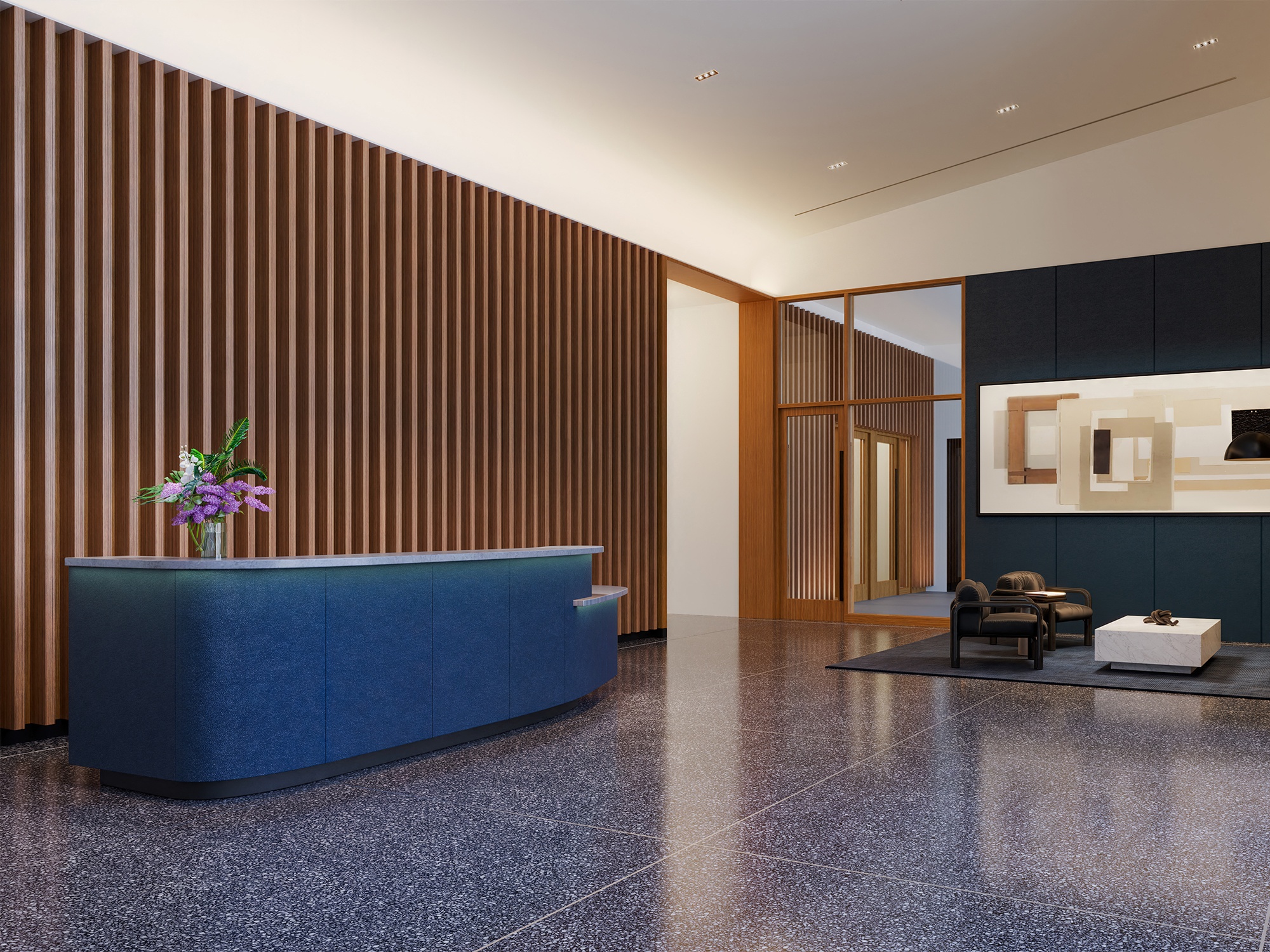 a lobby with a blue reception desk and a chair