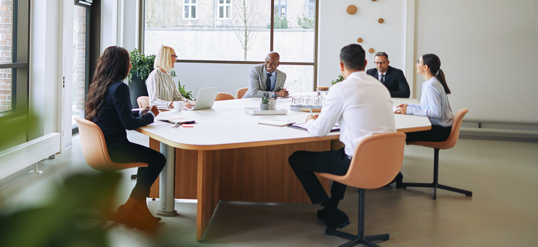 Wealth professionals collaborating around a boardroom table.
