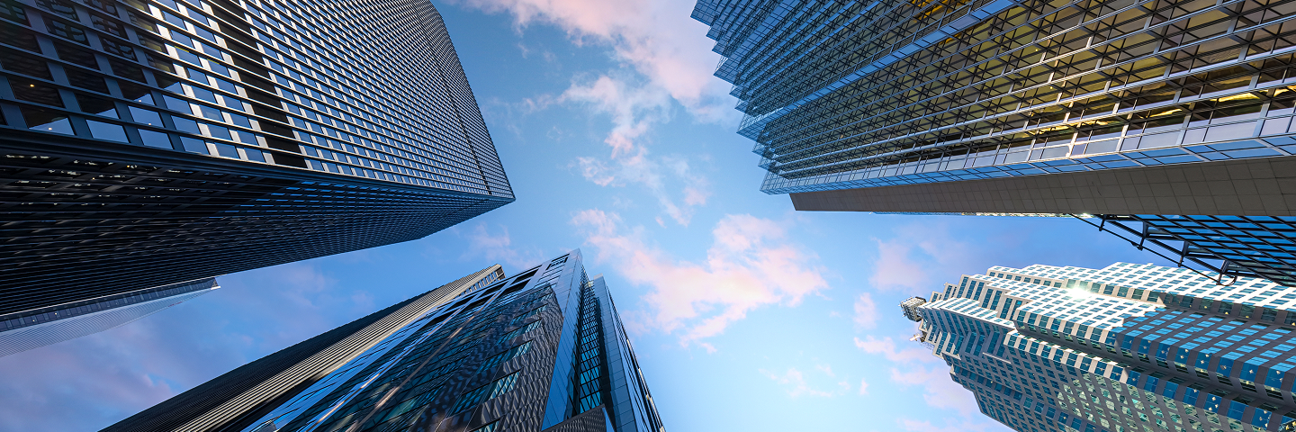 Street view looking up to the sky, with four office buildings towering above.