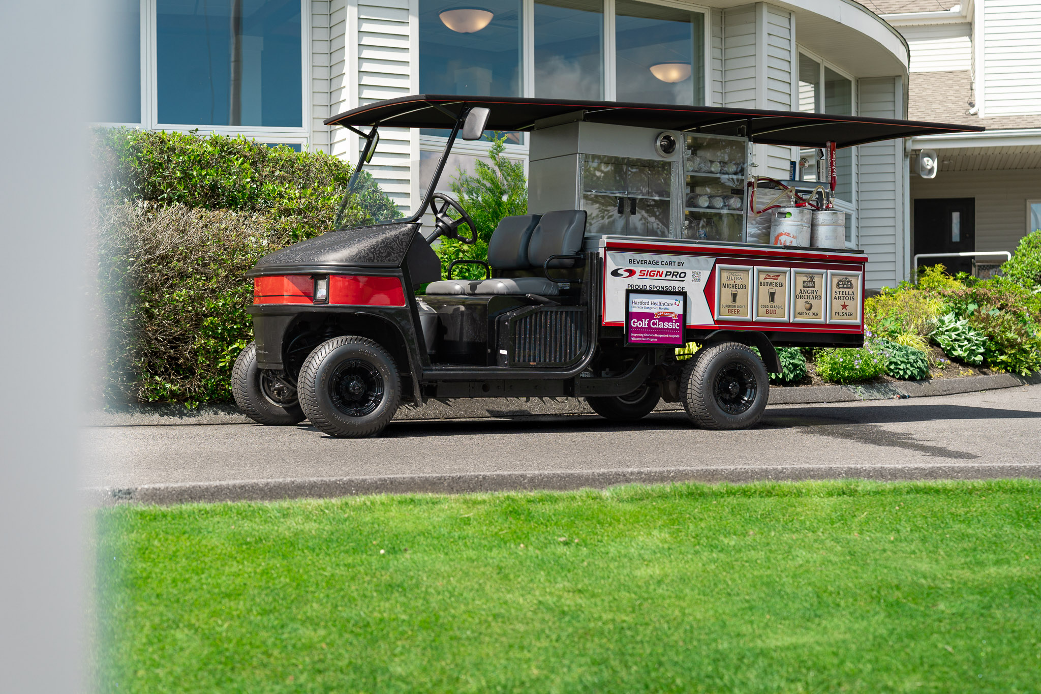 Custom golf course beverage cart wrap and event graphics produced by Sign Pro for a charity golf tournament.