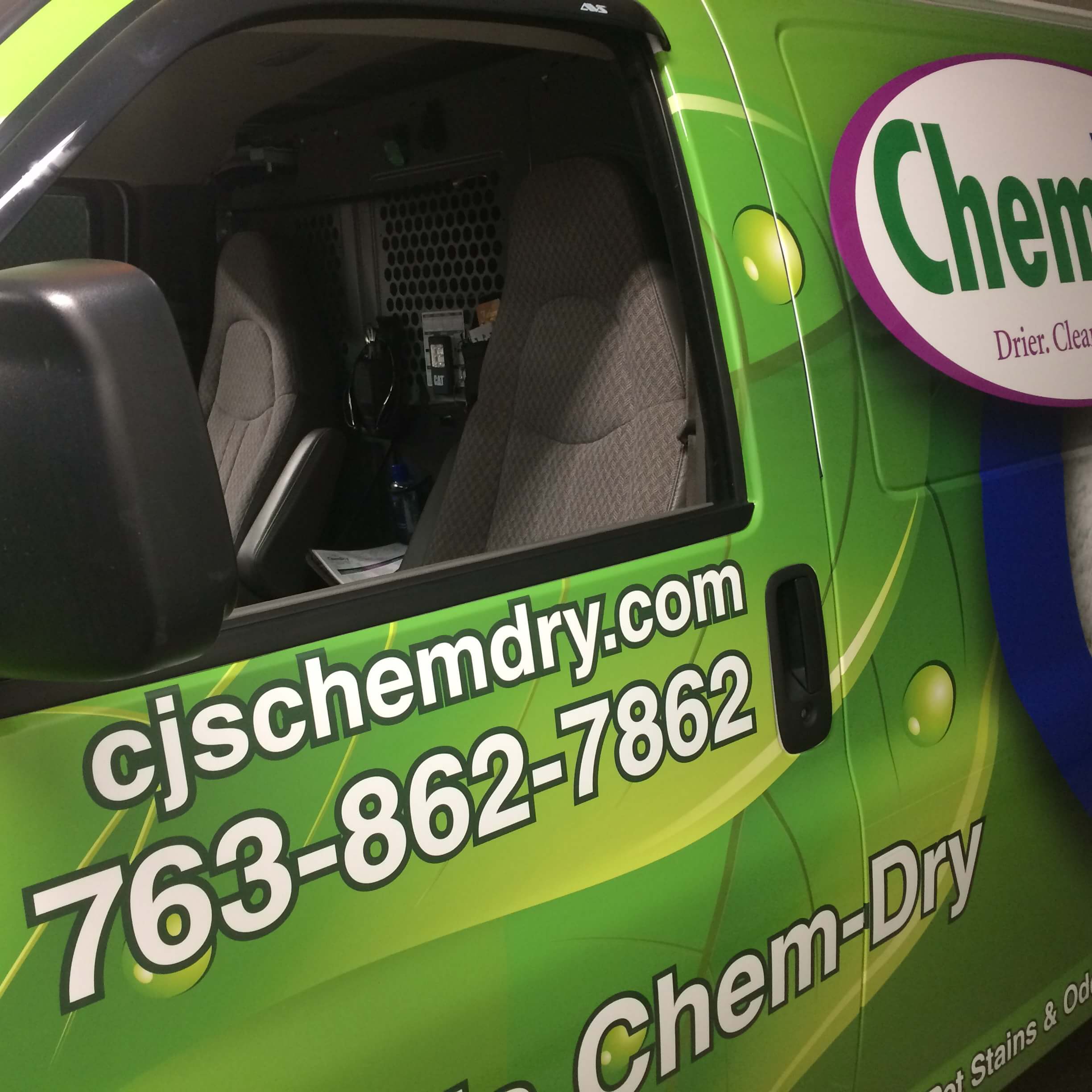 Close-up image of green CJ's Chem-Dry carpet cleaning van