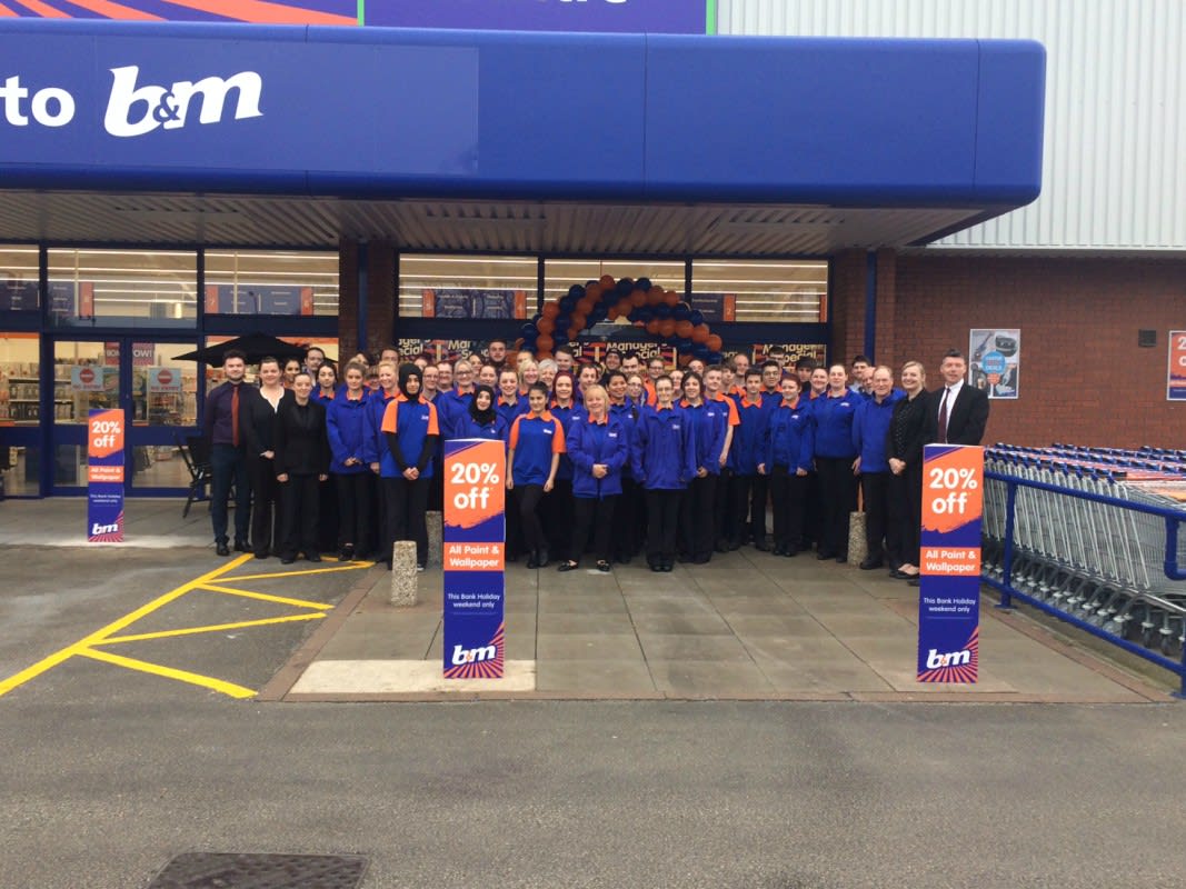 Store staff pose outside their new B&M Burton-upon-Trent store on Horninglow Road.