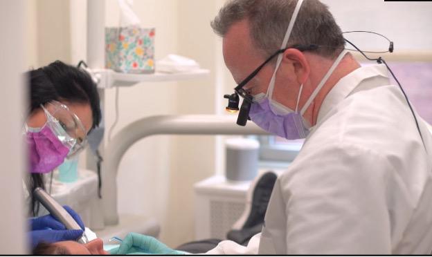 Dr. Mitchell Rubinstein of Studio 57 Dental treating a patient