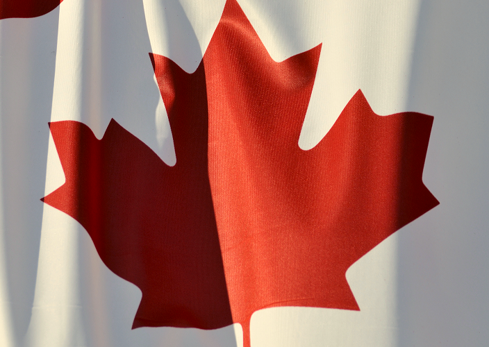Close-up of the Canadian flag, billowing in the wind.