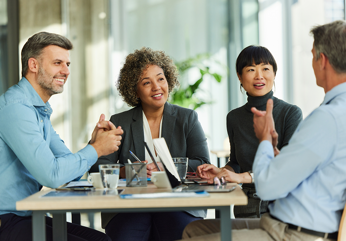 Two advisors in conversation with their clients.
